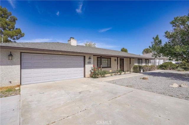 15084 Tacony Rd, Apple Valley, CA 92307 - single story home with a garage, driveway, stucco siding, and a chimney
