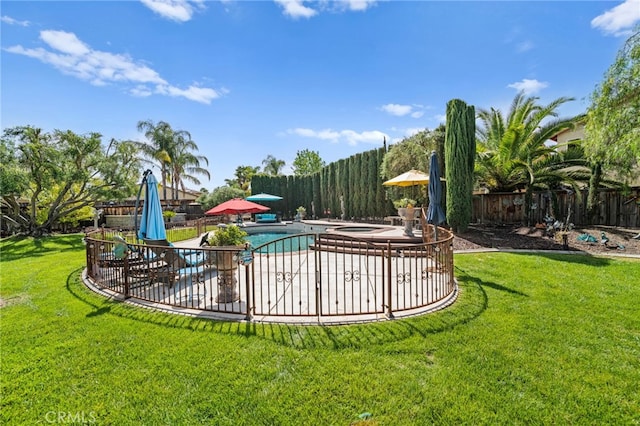 view of swimming pool with a fenced in pool, a patio area, a fenced backyard, and a lawn
