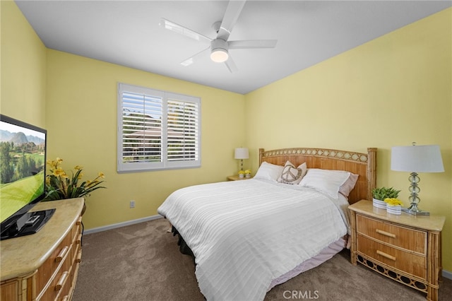 carpeted bedroom featuring baseboards and a ceiling fan
