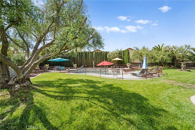 view of yard featuring a patio area, fence, and an outdoor pool