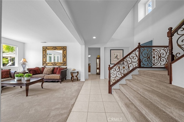 living area featuring light tile patterned flooring, stairway, and recessed lighting