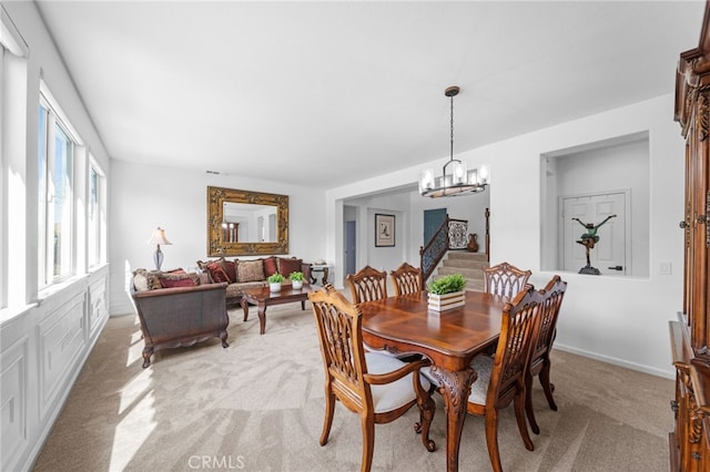 dining area featuring visible vents, a notable chandelier, and light carpet