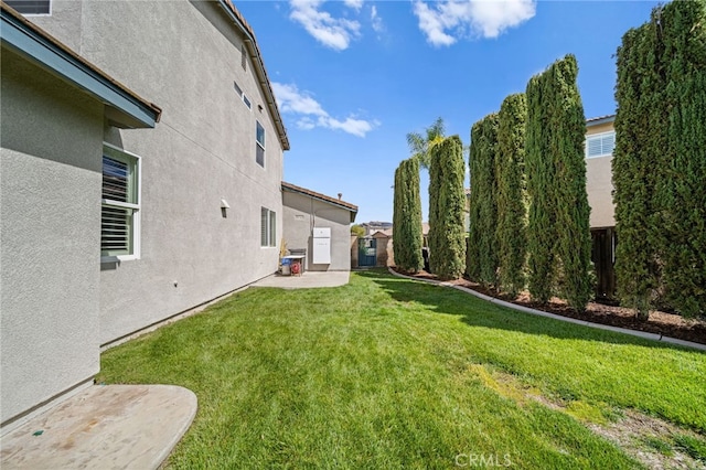 view of yard featuring a patio and fence