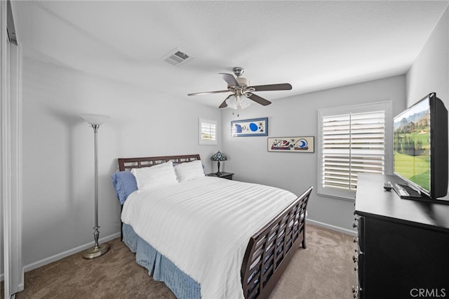 carpeted bedroom with ceiling fan, baseboards, and visible vents