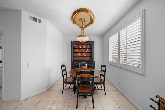 dining area featuring visible vents, baseboards, and light tile patterned flooring