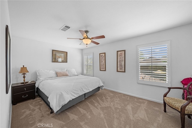bedroom with ceiling fan, baseboards, visible vents, and carpet floors