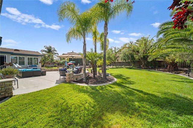 view of yard featuring a fenced backyard, an outdoor living space, and a patio