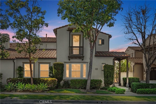 115 Vermillion, Irvine, CA 92603 - view of front of home featuring a tiled roof, a balcony, and stucco siding