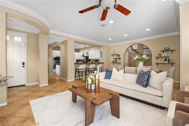 115 Vermillion, Irvine, CA 92603 - living room featuring light tile patterned floors, baseboards, arched walkways, ceiling fan, and crown molding