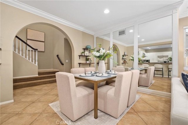 115 Vermillion, Irvine, CA 92603 - dining space with crown molding, visible vents, arched walkways, and light tile patterned floors
