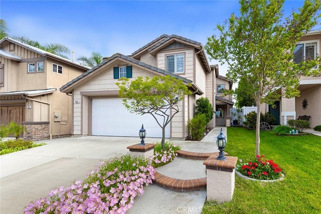 traditional home with concrete driveway, an attached garage, stucco siding, and a front yard