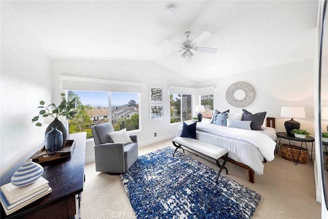 carpeted bedroom featuring lofted ceiling, ceiling fan, and multiple windows