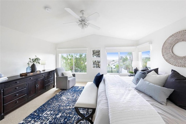 bedroom with baseboards, vaulted ceiling, a ceiling fan, and light colored carpet
