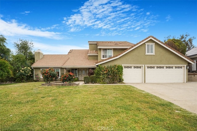 traditional home with a front yard, a garage, a chimney, concrete driveway, and stucco siding