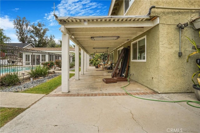 view of patio / terrace with fence and an outdoor pool