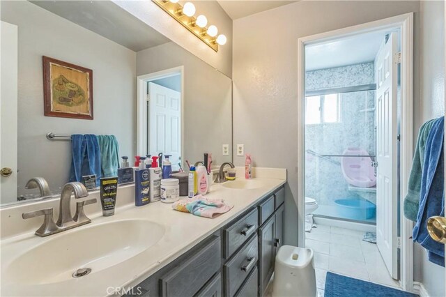 18641 Nathan Hill Dr Unit 8, Canyon Country, CA 91351 - bathroom featuring double vanity, a stall shower, a sink, and toilet