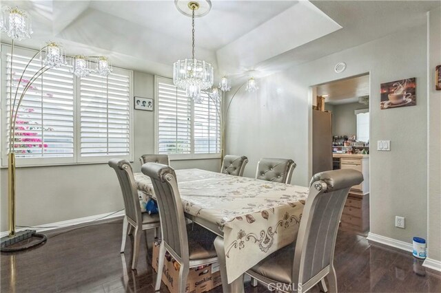 18641 Nathan Hill Dr Unit 8, Canyon Country, CA 91351 - dining space featuring a tray ceiling, baseboards, an inviting chandelier, and wood finished floors
