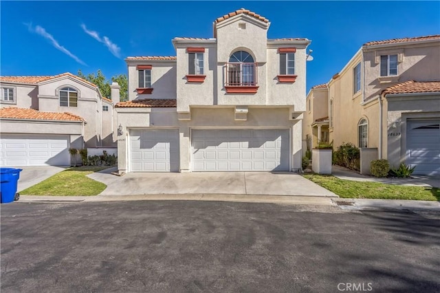 18641 Nathan Hill Dr Unit 8, Canyon Country, CA 91351 - mediterranean / spanish house with stucco siding, a tile roof, a balcony, an attached garage, and concrete driveway