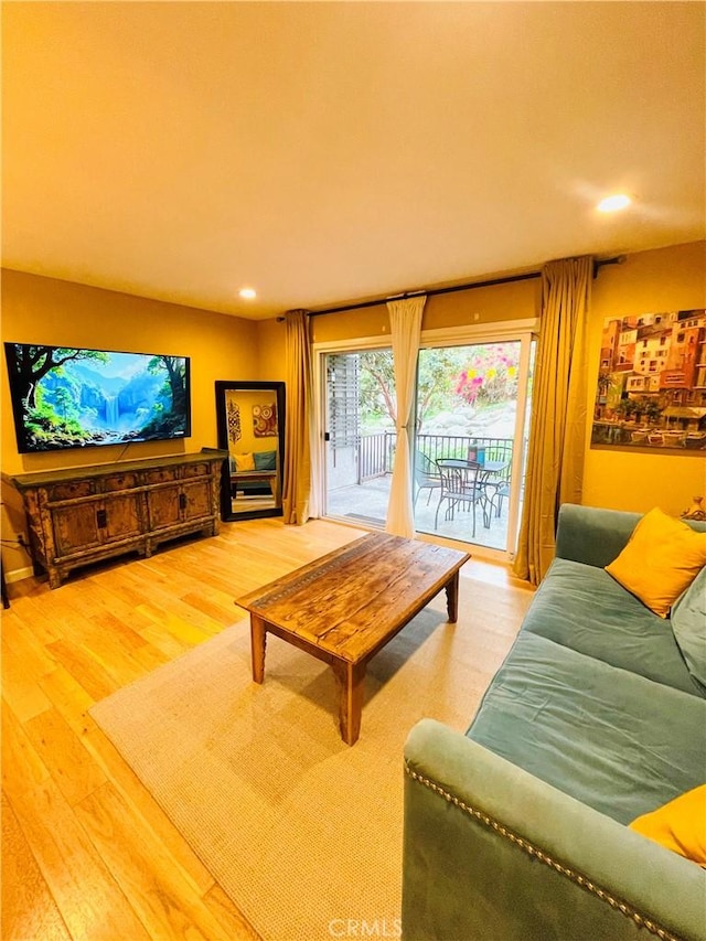living room with recessed lighting and wood finished floors