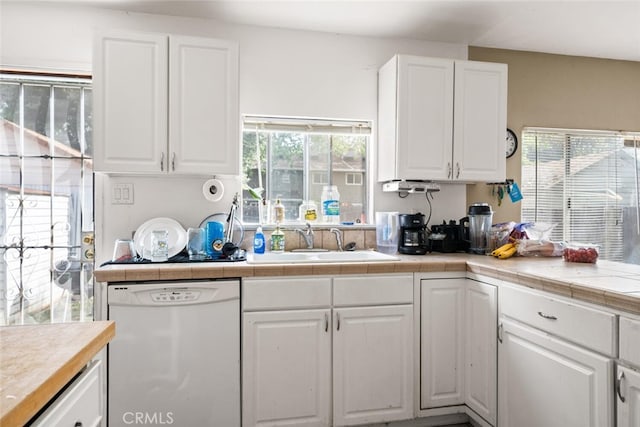 1109 Ivy St, Chico, CA 95928 - kitchen featuring white cabinets, dishwasher, a sink, and tile countertops