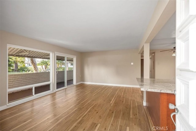 659 Avenida Sevilla Unit D, Laguna Woods, CA 92637 - unfurnished living room with baseboards, ceiling fan, and light wood-style flooring
