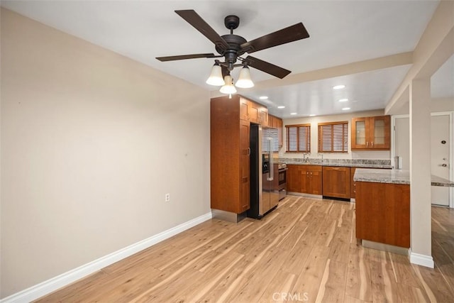 659 Avenida Sevilla Unit D, Laguna Woods, CA 92637 - kitchen featuring brown cabinetry, baseboards, recessed lighting, light wood-style flooring, and stainless steel appliances