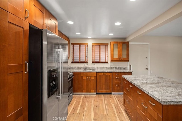 659 Avenida Sevilla Unit D, Laguna Woods, CA 92637 - kitchen featuring stainless steel appliances, brown cabinetry, glass insert cabinets, and light wood-style floors