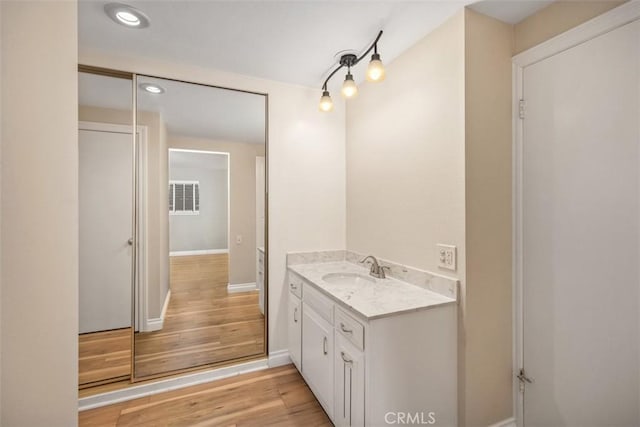659 Avenida Sevilla Unit D, Laguna Woods, CA 92637 - bathroom with vanity, recessed lighting, baseboards, wood finished floors, and visible vents