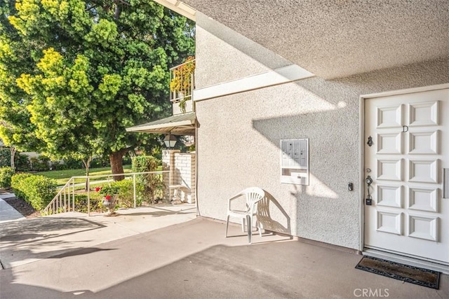 659 Avenida Sevilla Unit D, Laguna Woods, CA 92637 - doorway to property with a patio area and stucco siding