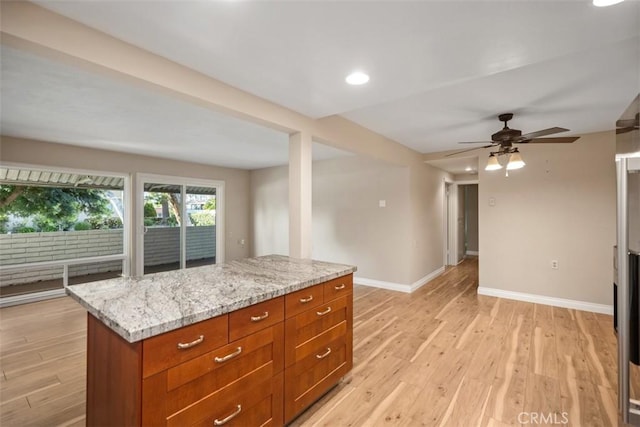 659 Avenida Sevilla Unit D, Laguna Woods, CA 92637 - kitchen featuring a ceiling fan, light stone countertops, light wood-type flooring, baseboards, and recessed lighting