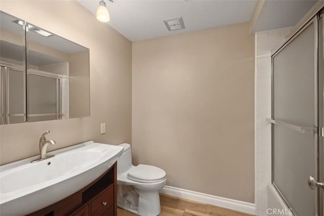 659 Avenida Sevilla Unit D, Laguna Woods, CA 92637 - full bath featuring vanity, toilet, enclosed tub / shower combo, baseboards, and wood finished floors