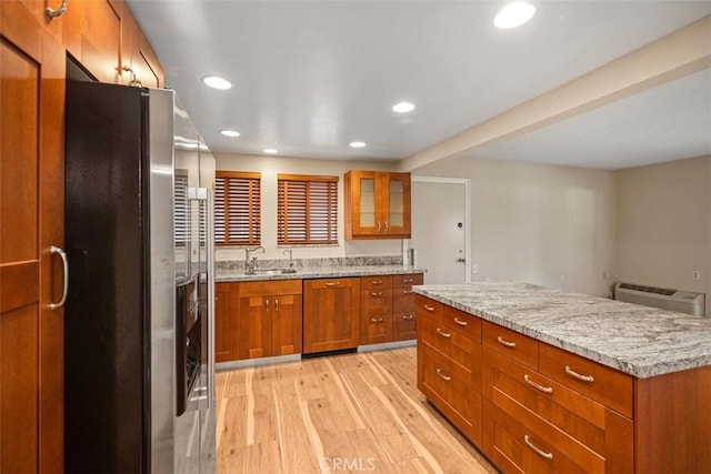 659 Avenida Sevilla Unit D, Laguna Woods, CA 92637 - kitchen with brown cabinetry, stainless steel refrigerator with ice dispenser, dishwasher, a sink, and light wood-style flooring