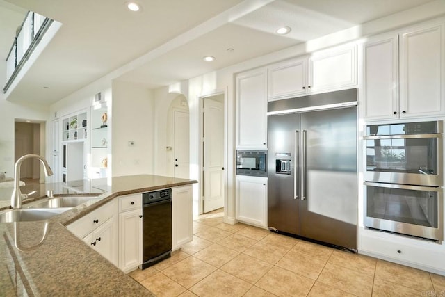 1664 Aryana Dr, Encinitas, CA 92024 - kitchen featuring built in appliances, arched walkways, white cabinets, light tile patterned floors, and recessed lighting