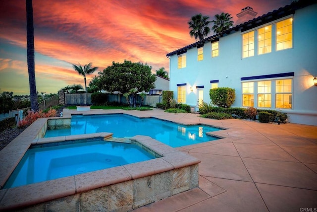 1664 Aryana Dr, Encinitas, CA 92024 - pool at dusk featuring a patio, a fenced backyard, and a pool with connected hot tub