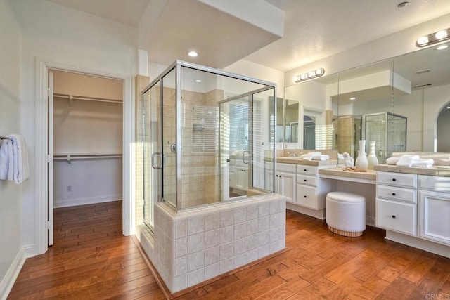 1664 Aryana Dr, Encinitas, CA 92024 - bathroom with vanity, a stall shower, wood-type flooring, a walk in closet, and recessed lighting