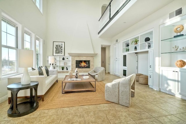 1664 Aryana Dr, Encinitas, CA 92024 - tiled living area with a towering ceiling, built in features, and a fireplace