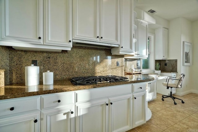 1664 Aryana Dr, Encinitas, CA 92024 - kitchen with stainless steel gas stovetop, exhaust hood, white cabinetry, light tile patterned flooring, and backsplash