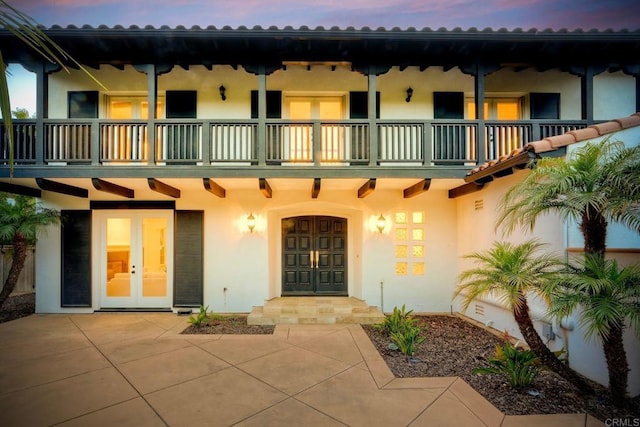 1664 Aryana Dr, Encinitas, CA 92024 - property entrance with a balcony, french doors, and stucco siding