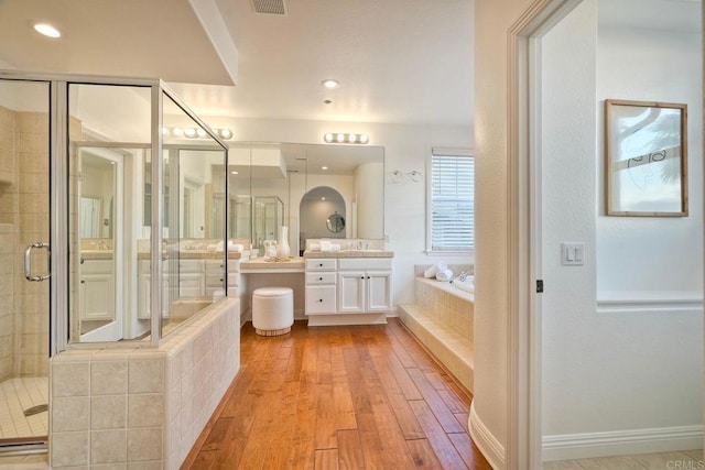 1664 Aryana Dr, Encinitas, CA 92024 - full bathroom featuring vanity, a bath, a stall shower, and wood-type flooring
