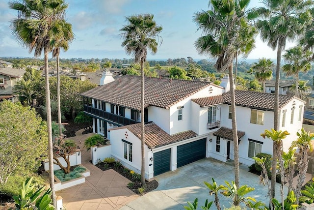 1664 Aryana Dr, Encinitas, CA 92024 - mediterranean / spanish-style house featuring a tile roof, stucco siding, a garage, and concrete driveway