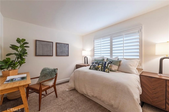 bedroom with baseboards and carpet floors