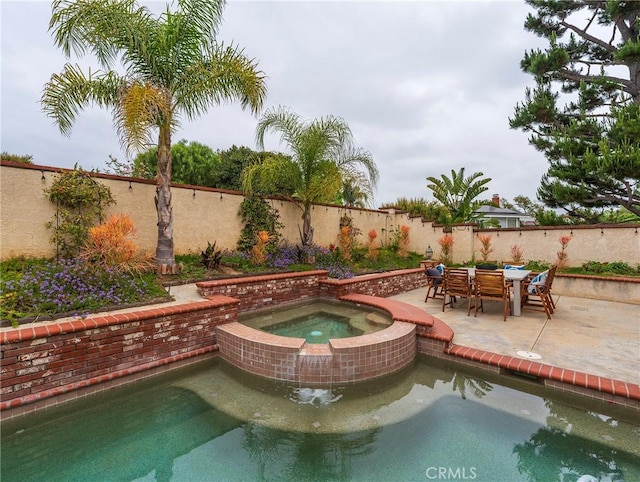 view of swimming pool featuring a patio, a fenced backyard, and an in ground hot tub
