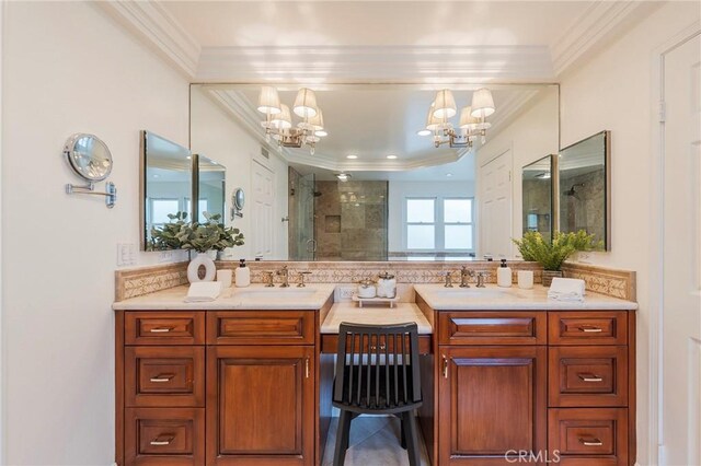 full bathroom featuring a chandelier, vanity, a shower stall, and crown molding