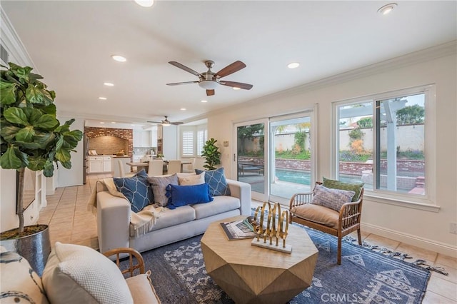 living area featuring crown molding, light tile patterned floors, a ceiling fan, recessed lighting, and baseboards