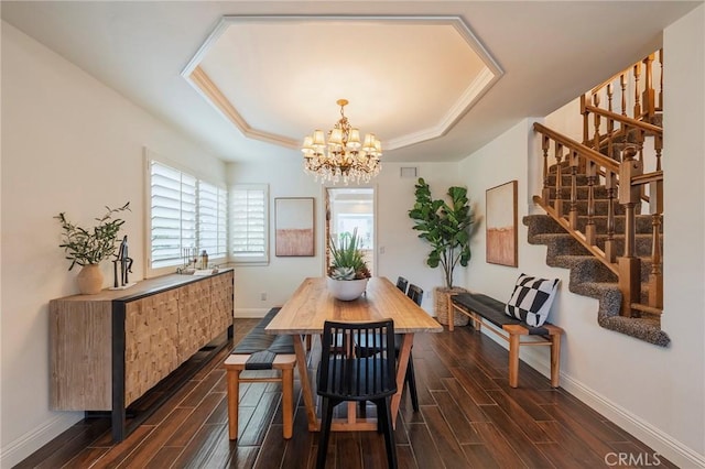 dining space with a notable chandelier, baseboards, and wood tiled floor