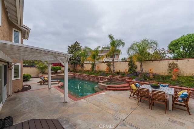 view of swimming pool with a pergola, a patio area, a fenced backyard, and a pool with connected hot tub