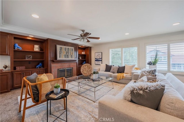 living room with ornamental molding, recessed lighting, a ceiling fan, and a brick fireplace