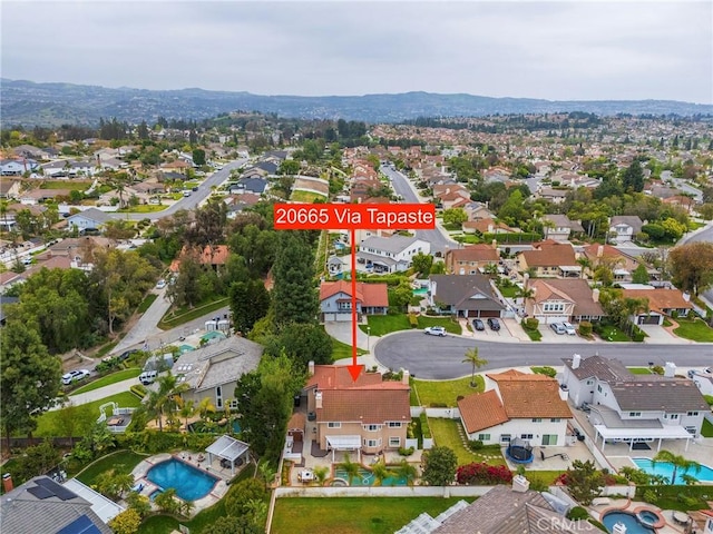 drone / aerial view featuring a residential view and a mountain view