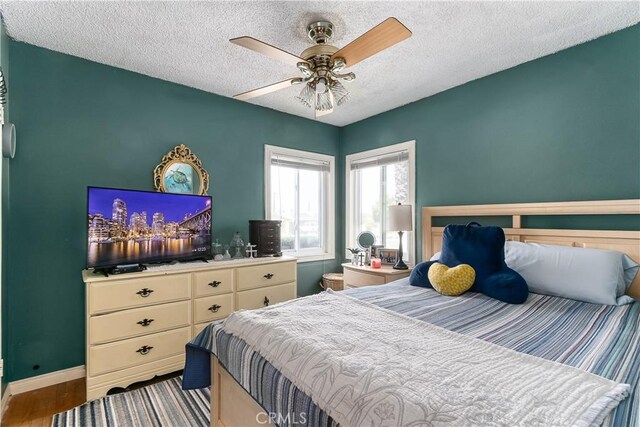 11947 Vivienda Ct, Grand Terrace, CA 92313 - bedroom with baseboards, ceiling fan, wood finished floors, and a textured ceiling