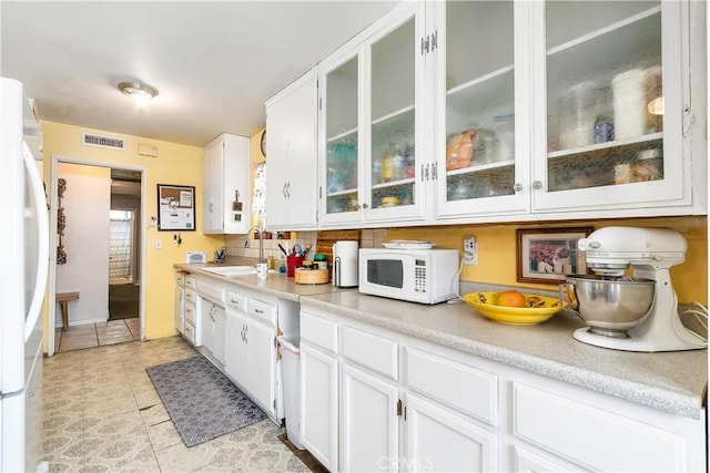 11947 Vivienda Ct, Grand Terrace, CA 92313 - kitchen featuring white appliances, light countertops, white cabinets, visible vents, and a sink